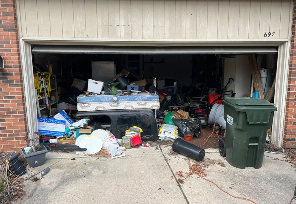 Packed garage full of clutter before junk removal service.
